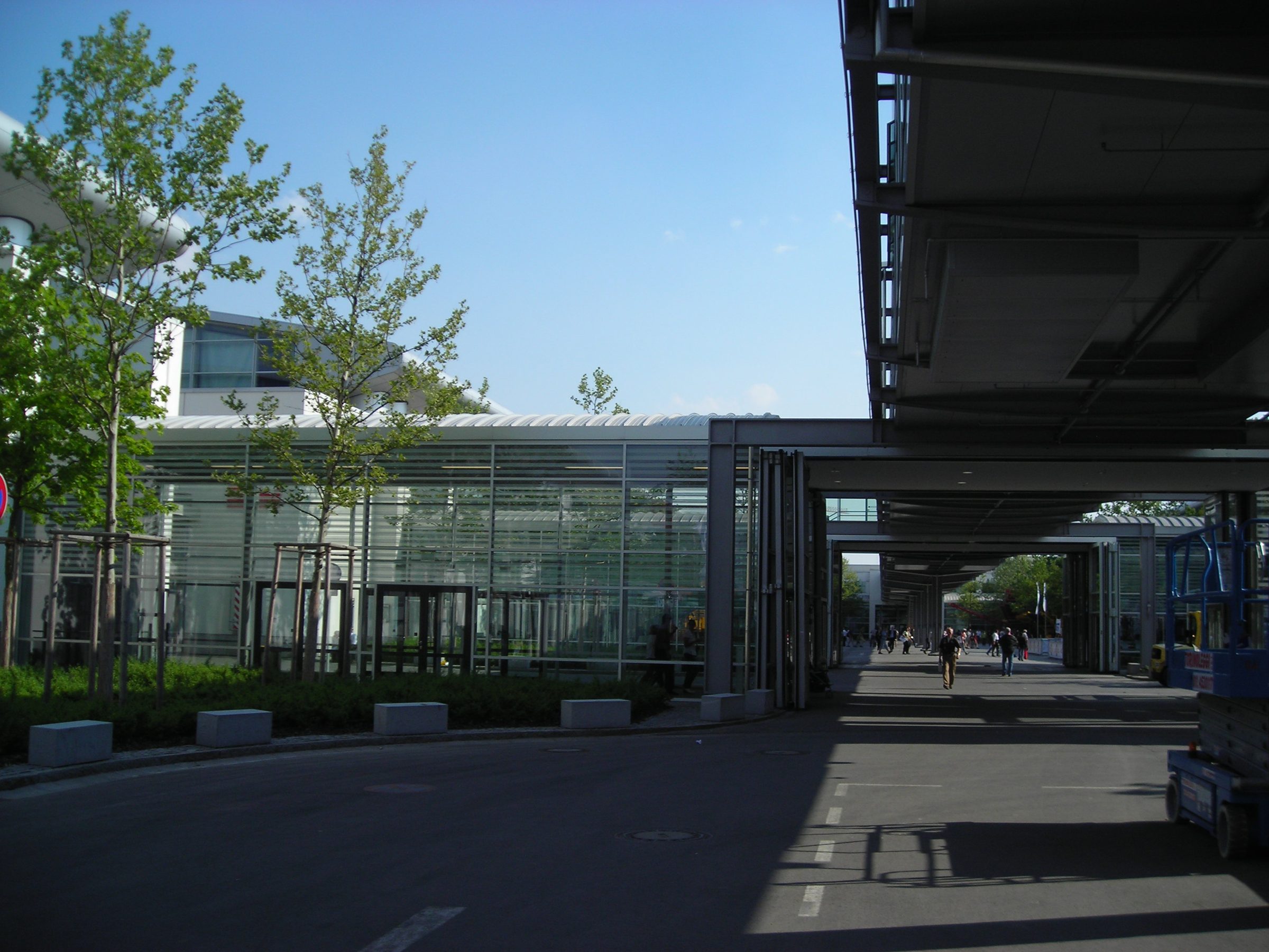 Glasfassade und überdachter Verbindungsgang zwischen den Hallen der Messe München